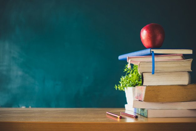 school books with red apple desk green school board background 2379 1625